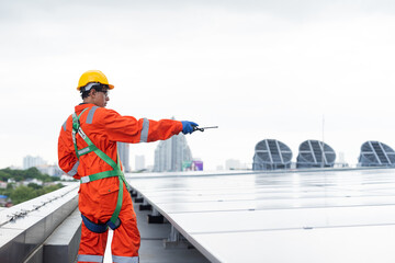 Solar panel rooftop, Rooftop solar power. Engineer or technician inspecting installation quality of solar power systems on rooftop of building. Male engineer checks solar panel on rooftop