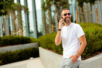 Man in casual attire engages in friendly conversation while enjoying a sunny day outdoors in an...