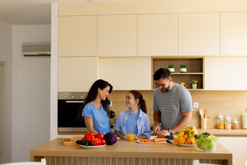Family bonding through cooking and preparing healthy meals in a modern kitchen in the morning light