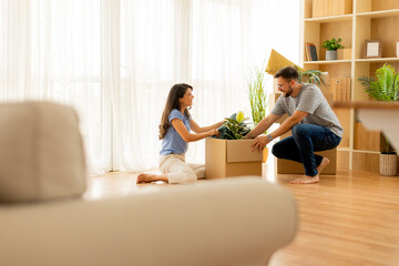 Excitement fills the air as a couple unpacks treasured belongings in their new home together