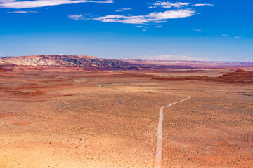 Aerial view of a winding road through the Valley of the Gods located in Utah. This scene captures...