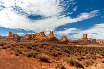 Rugged sandstone rock formation, pinnacle or Hoodoo rises prominently against a backdrop of cloudy...