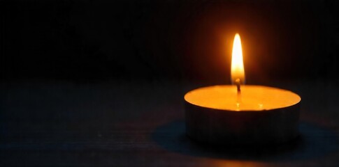 Warm Yellow Candlelight Glow Close-up of a Single Candle Being Lit, Soft Illumination Against Dark Background. Perfect for Relaxation, Meditation, Spiritual, and Home Decor Themes.