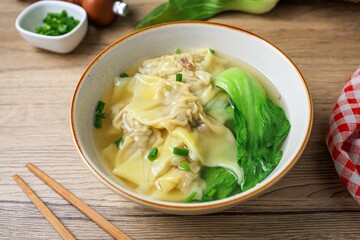 Wonton with bok choy Soup in a ceramic bowl	