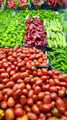 Fresh fruits and vegetables placed on cases and stands in the grocery section