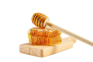 Honeycombs with honey spoon on wooden board isolated on white.