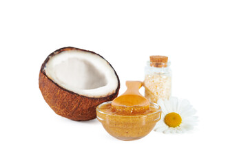 Broken coconut, scrub and chamomile flower. Isolated on white.