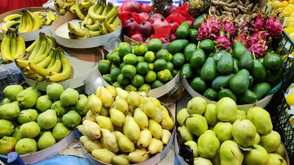 Fresh fruits and vegetables placed on cases and stands in the grocery section