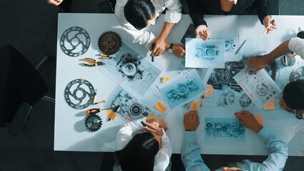 Top down view of skilled engineer showing and talking about turbine engine design. Aerial view of...
