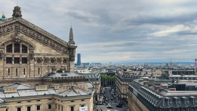 Panoramic top view of Paris, the Palais Garnier (Garnier Opera) building, rooftops and Eiffel Tower from the free observation deck on the roof of the Galeries Lafayette.
