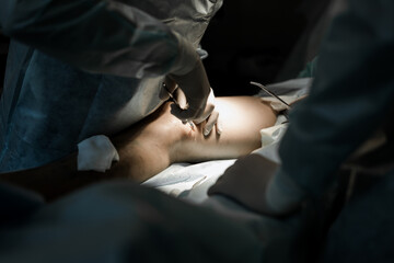 Doctor performing endovenous laser treatment (EVLA) for varicose veins. Minimally invasive vascular surgery in modern medical clinic.