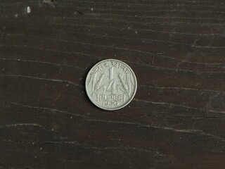 Indian coin quarter rupee on wooden table