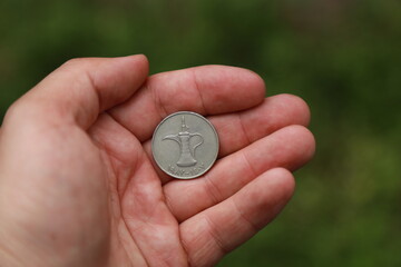 Coin one dirham of United Arab Emirates in hand