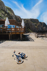 Sunny Day Scene with a Bicycle and Outdoor Dining Area on the Coast
