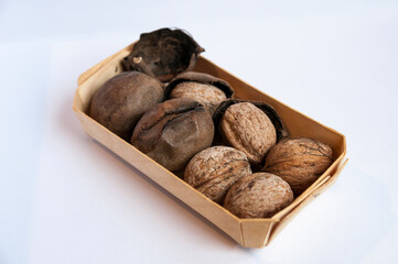 Side view of box with inshell walnuts and skins
