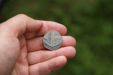 Coin of Great Britain in hand