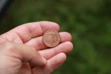 Coin of Great Britain in hand