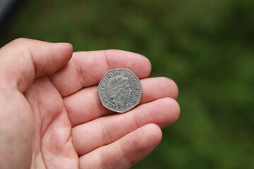 Coin of Great Britain in hand