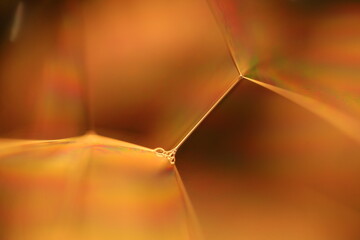 	
Orange coloured liquid surface, fluid effect, bright chemistry, geometric shapes