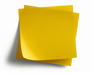 A blank yellow sticky note is isolated, ready for an office message or reminder
