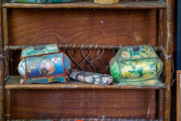 Wooden sideboard with decorative retro-style boxes – colorful, patterned chests displayed on the shelf as a vintage interior detail.