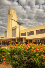 Estação Ferroviária desativada em Goiania – beleza arquitetônica em tempo nublado com um jardim florido em primeiro plano.