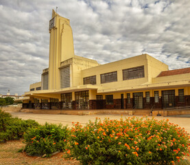 Estação Ferroviária desativada em Goiania – beleza arquitetônica em tempo nublado com um jardim florido em primeiro plano.