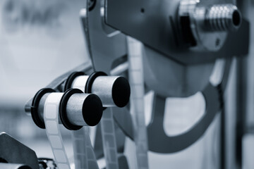 Fragment of the conveyor of sticking labeling machine. Abstract industrial background.