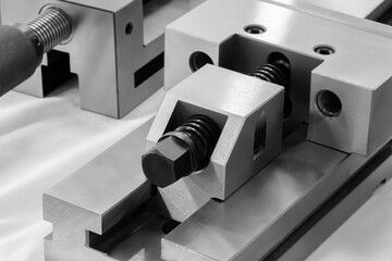 Metal parts fastening system in metalworking machines, industrial concept background