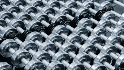 Conveyor belt with a white handle on the end. belt is made of metal and is silver in color.