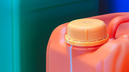 Red plastic container with yellow lid for fuel oil or other liquids, liquid packaging concept.