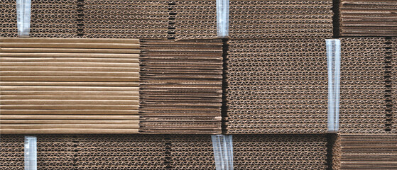 Elements of corton cardboard boxes are collected in stack. Conveyor line for production of boxes....