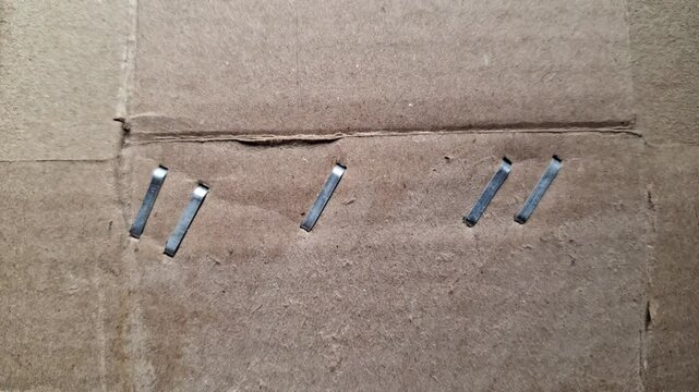 Metal staple on brown cardboard