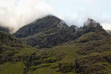 Carrauntoohil mountain is covered by clouds in County Kerry, Ireland. Moss and grass cover the...