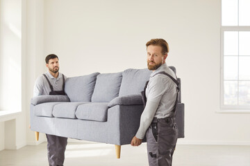 Professionally trained furniture movers, delivering sofa, upholstery, repair services advertisement, relocation at home placing new modern comfy couch in living room, office moving day renovation 