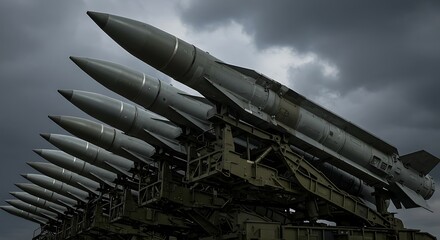 Naklejka premium Row of Surface to Air Missiles Ready for Launch Against a Dark Sky