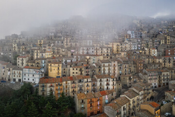 Sunrise view of the rooftops of Gangi with morning fog. Sicily, Italy. August 2024. Aerial drone picture.