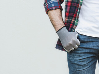Attractive man, work clothes and protective gloves. Labor day. Front view, close up, studio shot....