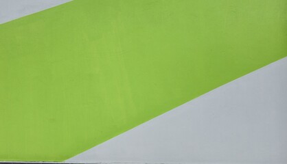 Cement walls painted green and white. Building walls painted in two diagonal colors.