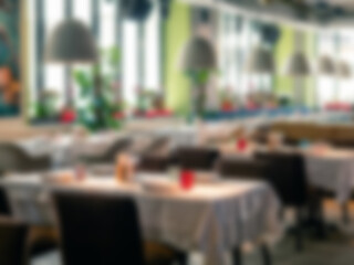 Background blurred counter coffee bar with tables. Restaurant cafe, cafe blurred background with bokeh. Abstract blur coffee shop and cafe restaurant for defocused background