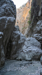 Stream in deepest narrow stone canyon Saklikent in national park in Mugla Province in southwestern Turkey. Vertical image