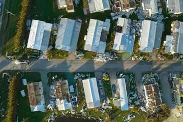 Consequences of natural disaster. Severely damaged houses after hurricane Ian in Florida mobile home residential area