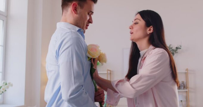 Angry woman rejects apology flowers. Man says sorry for forgetting about anniversary or Valentine's Day holiday celebration and gives bouquet to annoyed displeased resentful wife who rejects gift