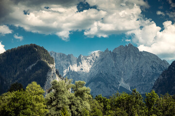 Mountains panorama detail from Admont with dramatic clouds on sky and trees on foreground,...