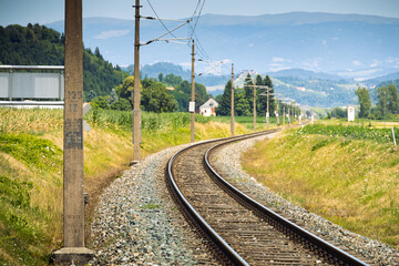 Railway tracks in Austria with Alps on background