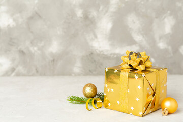 Golden gift box with christmas decor on wooden table