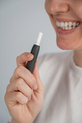 Woman smoking tobacco heating system. Electronic cigarette.