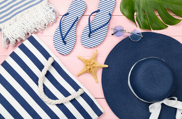 Blue beach accessories on wooden background, top view. Flat lay