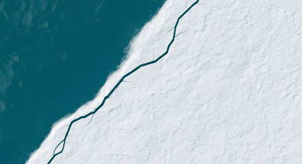 Obraz premium Aerial view of arctic ice sheet and ocean water crack climate change concept
