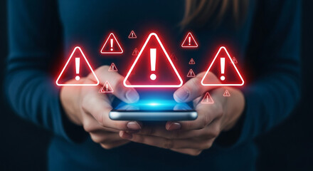 Hands hold phone, glowing red warning triangles appear, symbolizing online security risks, digital threats, and urgent alerts needing immediate attention
